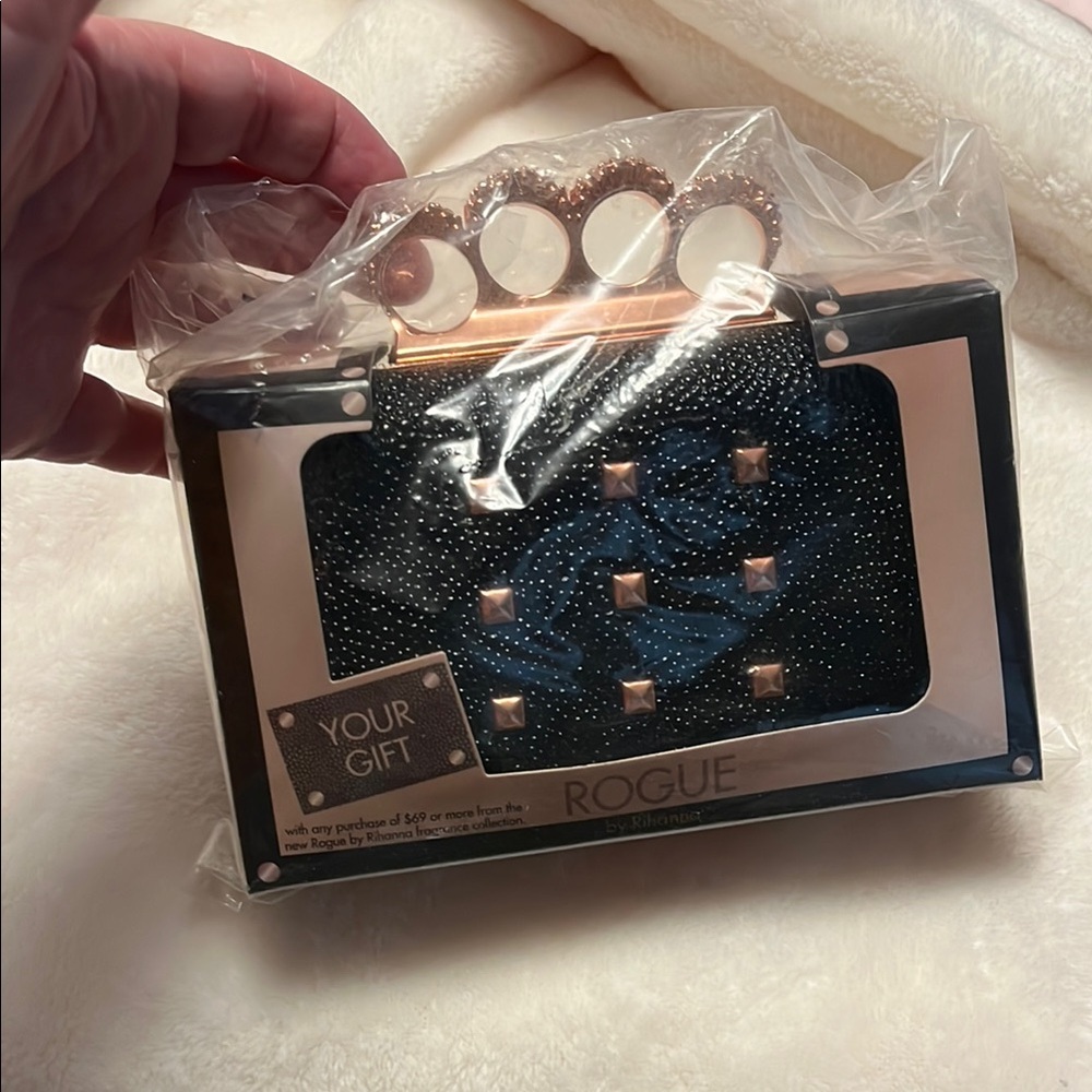 Black clutch with rose gold accents.